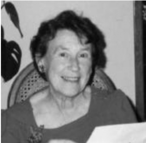 A black and white photo of Doris Crowston sitting and smiling. 