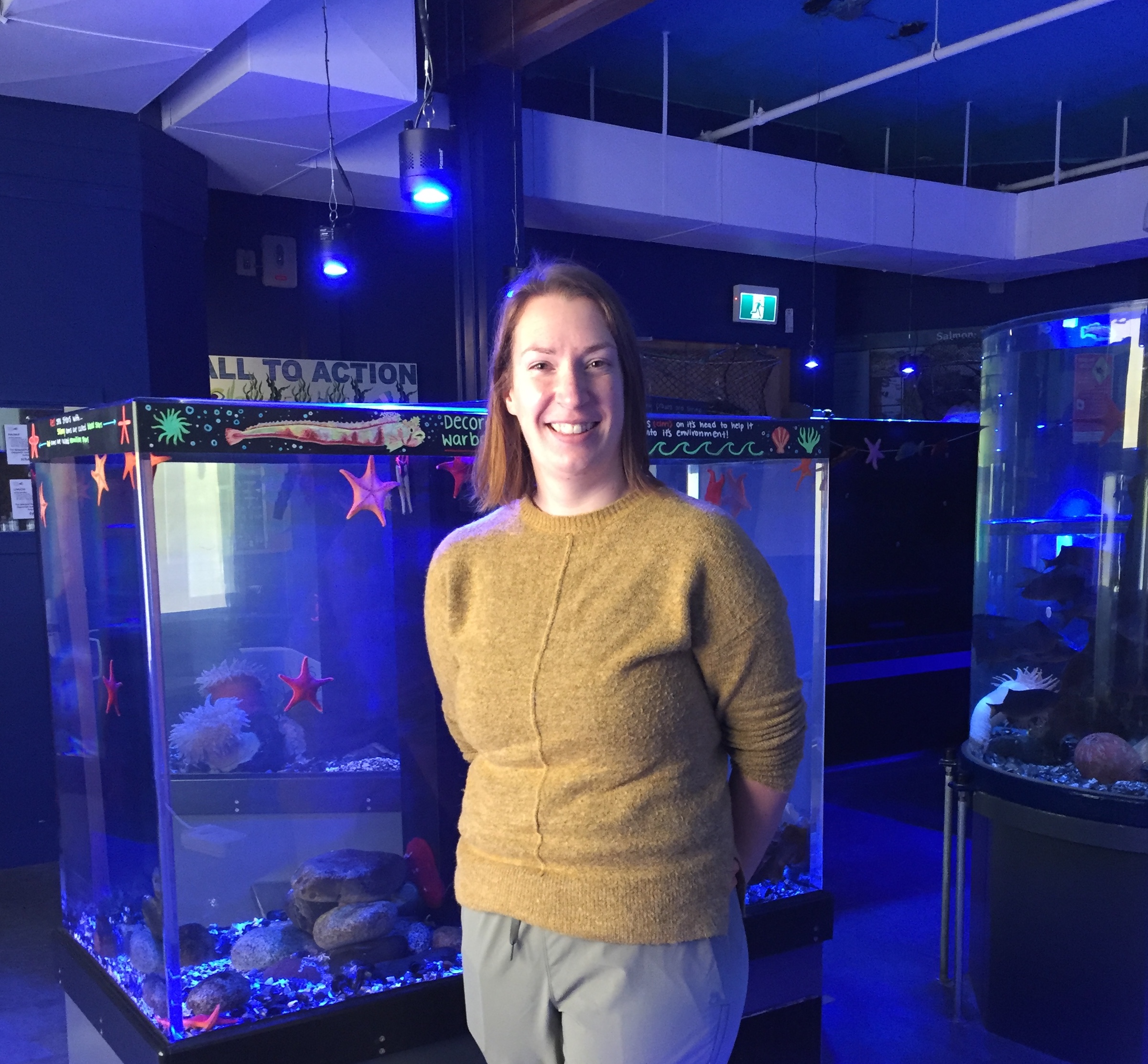 Jenny Wright, Curator at the Nicholas Sonntag Marine Education Centre stands beside one of the aquariums